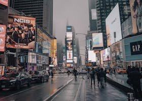 Rainy day in Times Square capturing lively urban atmosphere and vibrant billboards.